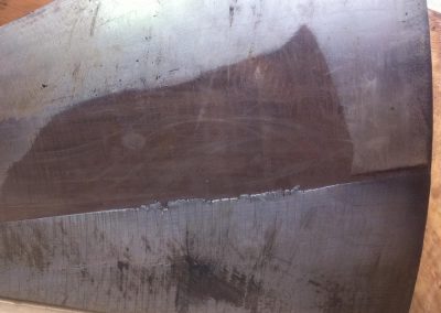 Wood chipper face plate with Avweld hardfacing on the bottom half.
